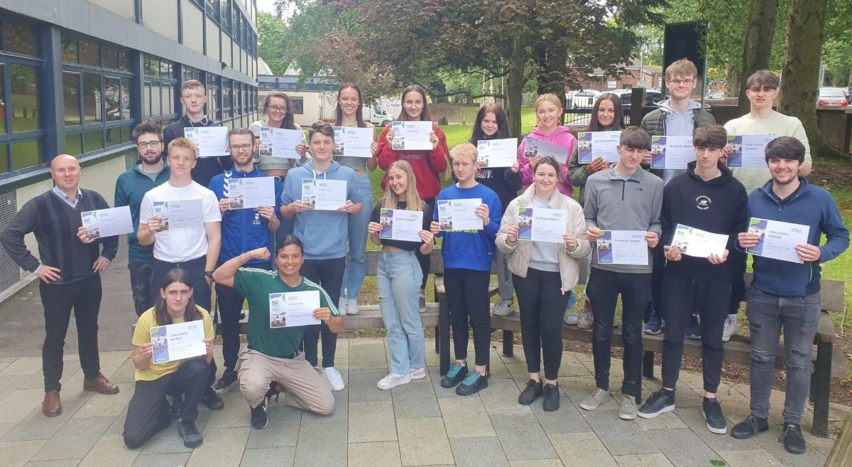 Students proudly display their Volunteer Impact Awards